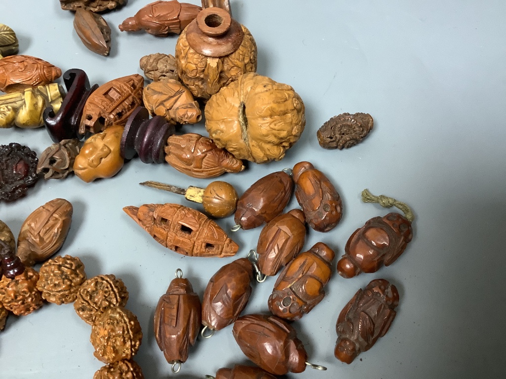 An assortment of Chinese peach stone and a nut carvings